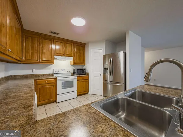 a kitchen with a sink cabinets and stainless steel appliances