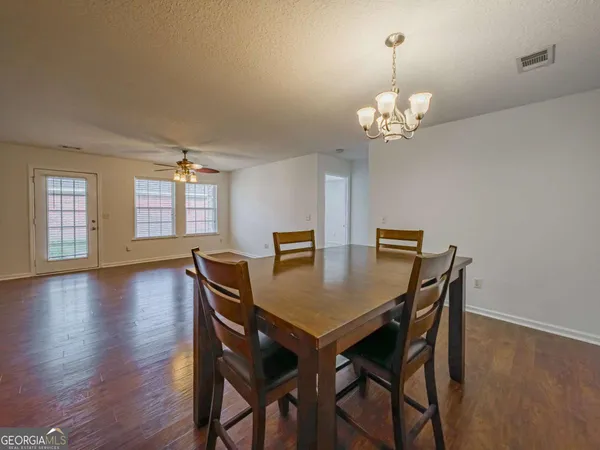 a view of a dining room with furniture wooden floor and chandelier