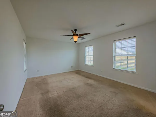 a view of a livingroom with a ceiling fan and window