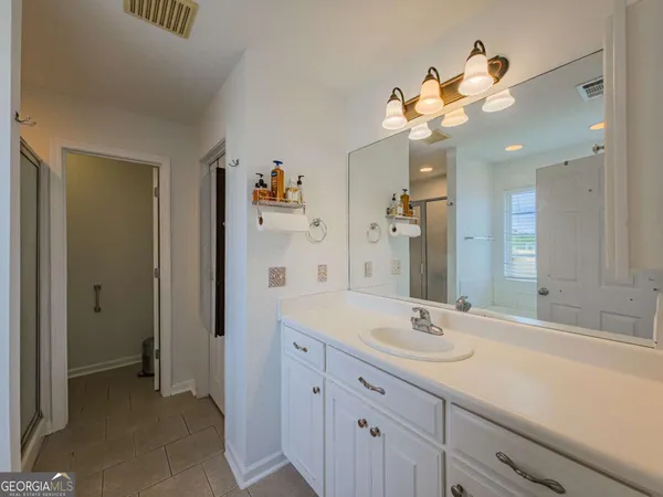 a bathroom with a sink a vanity and a mirror