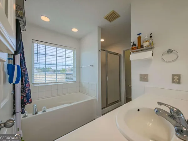 a bathroom with a bathtub and a sink
