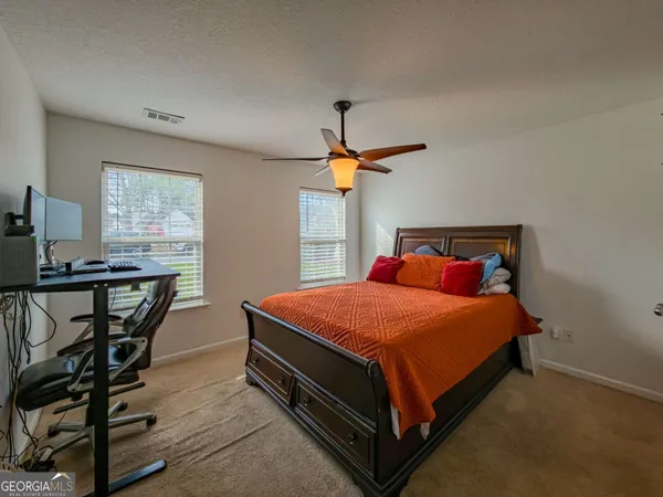 a bed sitting in a bedroom next to a window