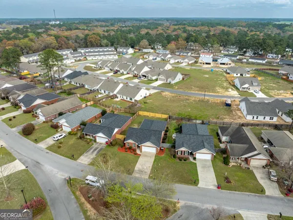 an aerial view of residential houses with outdoor space