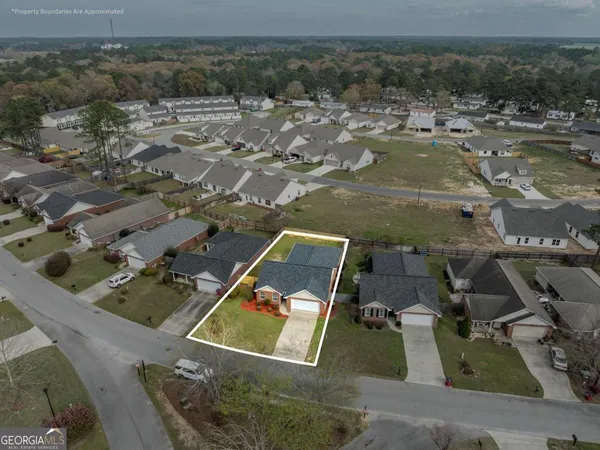 an aerial view of residential houses with outdoor space