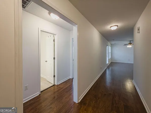 a view of a hallway with wooden floor