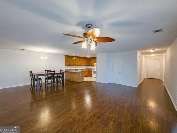 a view of a dining room with furniture and chandelier