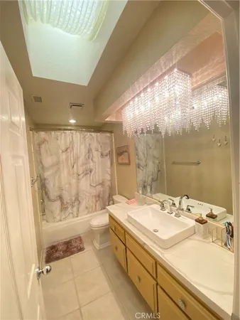 a bathroom with a tub a sink and mirror