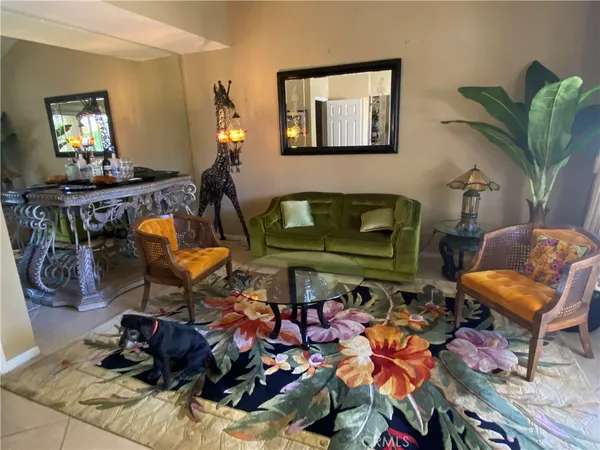 a living room with furniture a window and gym equipment