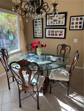 a view of a dining room with furniture a chandelier and wooden floor