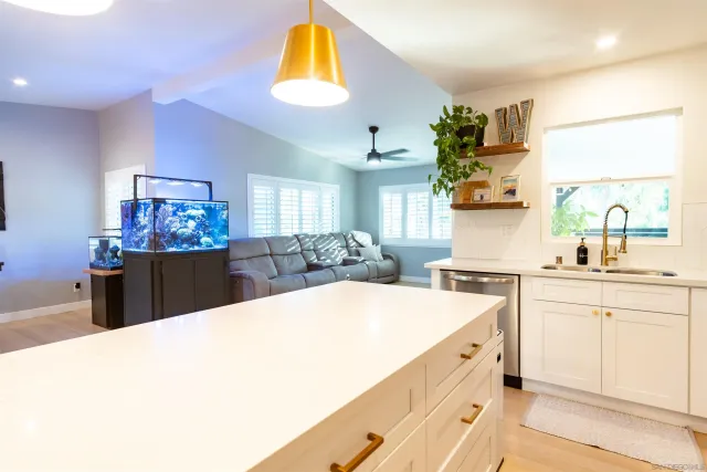 a kitchen with cabinets and chairs