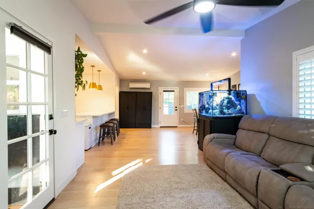 a bed sitting in a bedroom and dresser with wooden floor