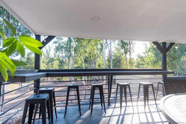 a view of a house with a yard and potted plants
