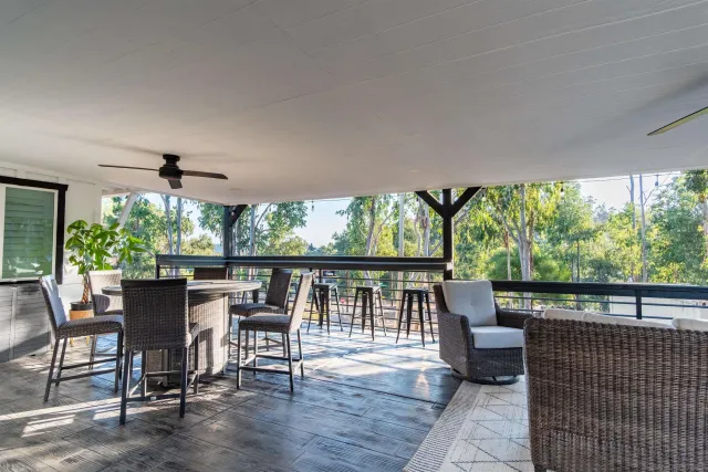 a view of backyard with outdoor seating and green space