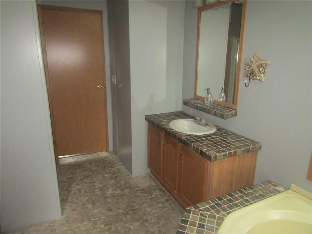 521 Williams Street Confluence, PA 15424 - Photo 21 of 38 a bathroom with a granite countertop sink and a mirror