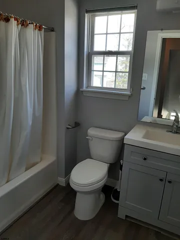 a bathroom with a toilet a sink and shower