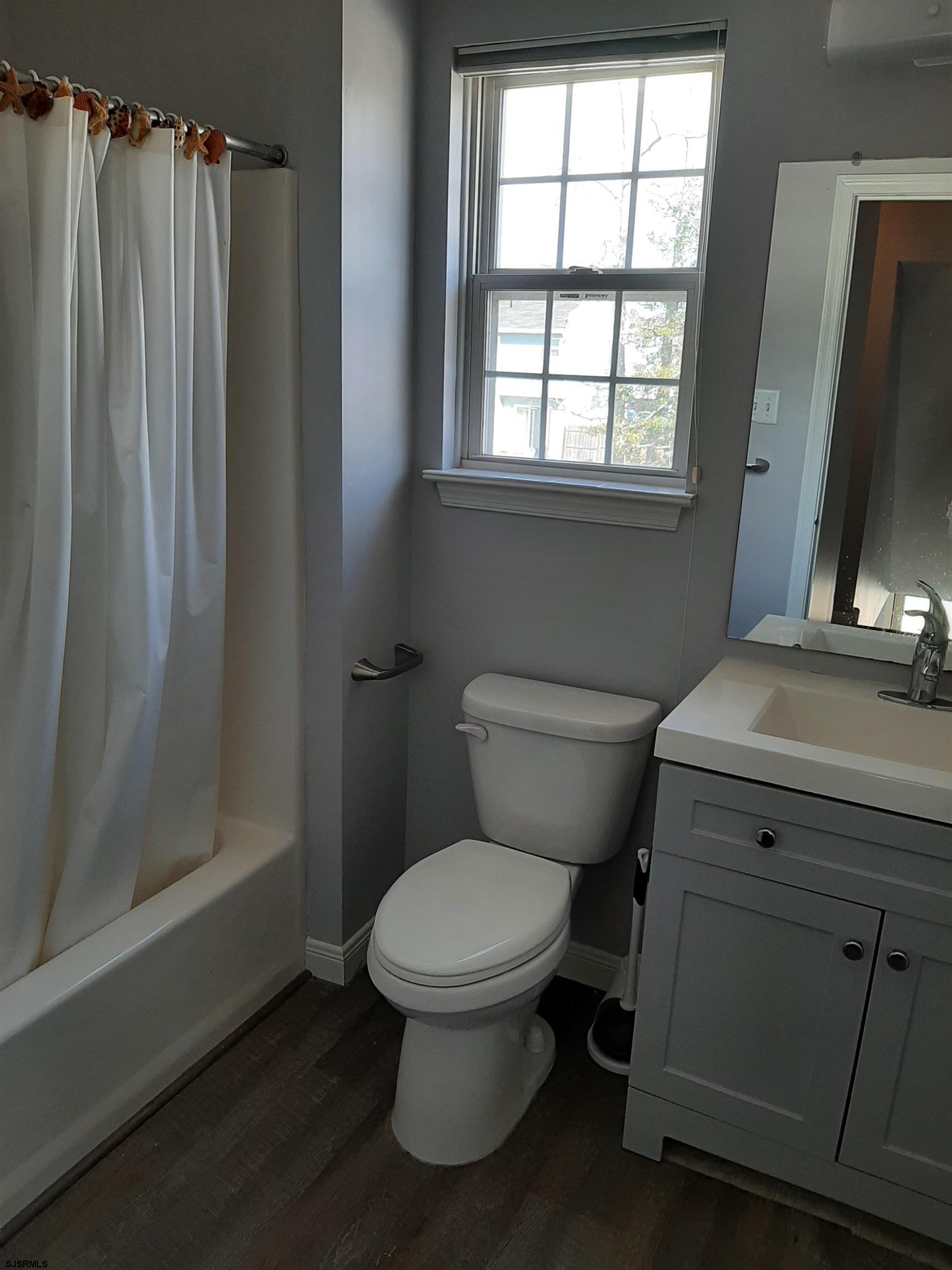 9 Pacific Avenue, Unit 9 Somers Point, NJ 08244 - Photo 11 of 19 a bathroom with a toilet a sink and shower