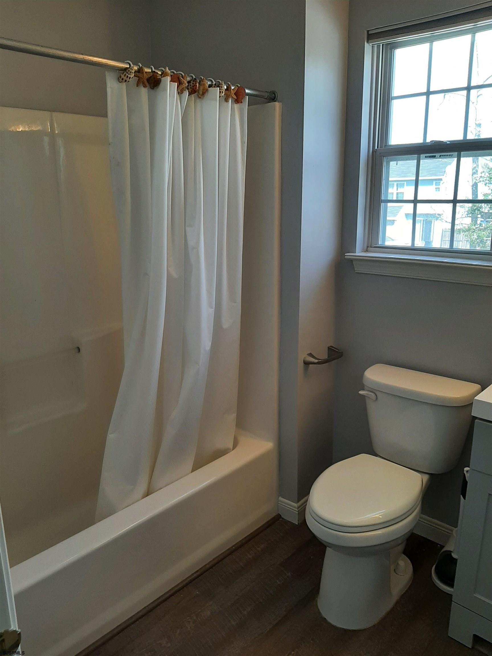 9 Pacific Avenue, Unit 9 Somers Point, NJ 08244 - Photo 13 of 19 a white toilet sitting next to a window