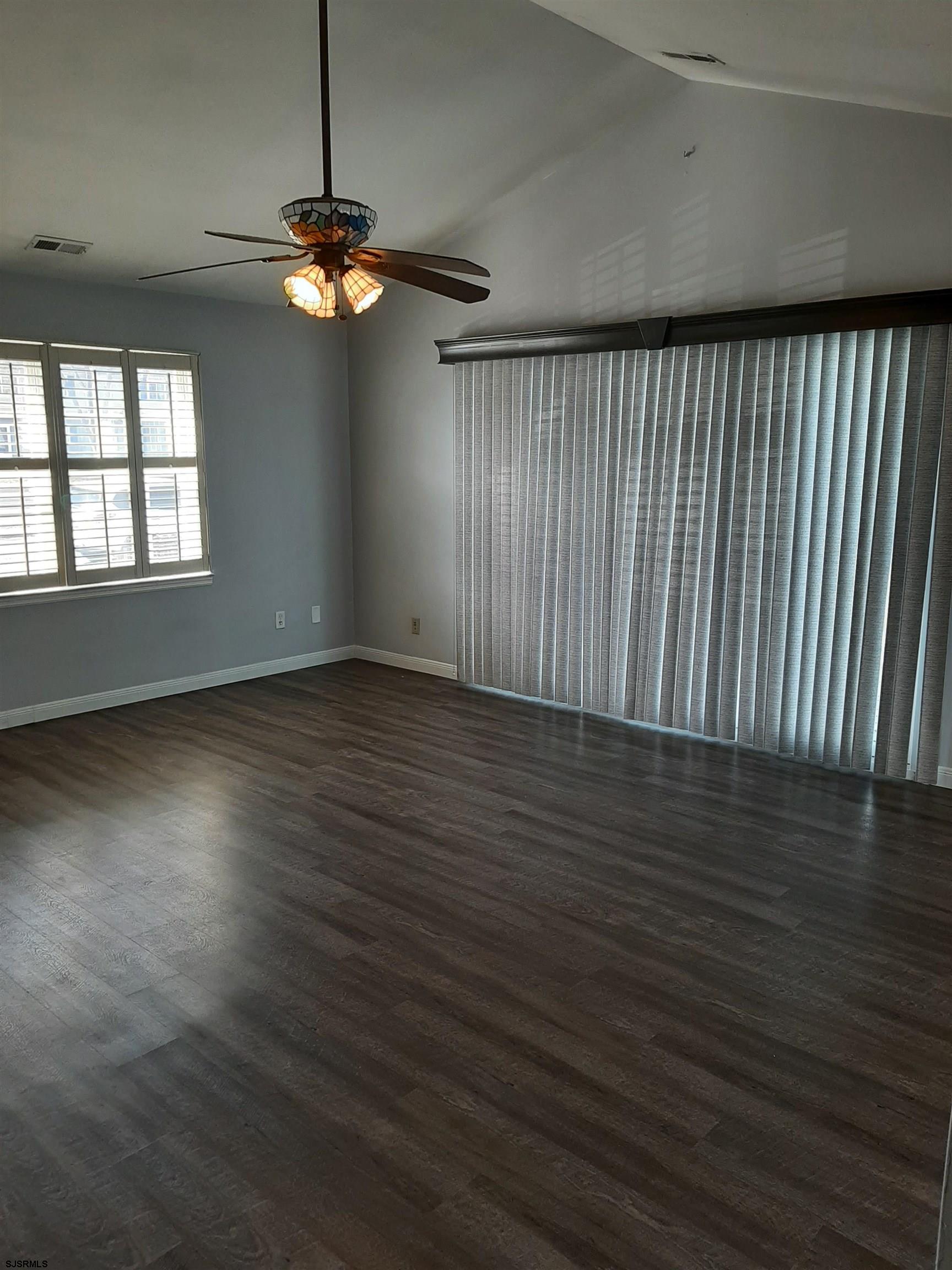 9 Pacific Avenue, Unit 9 Somers Point, NJ 08244 - Photo 14 of 19 an empty room with wooden floor fan and windows