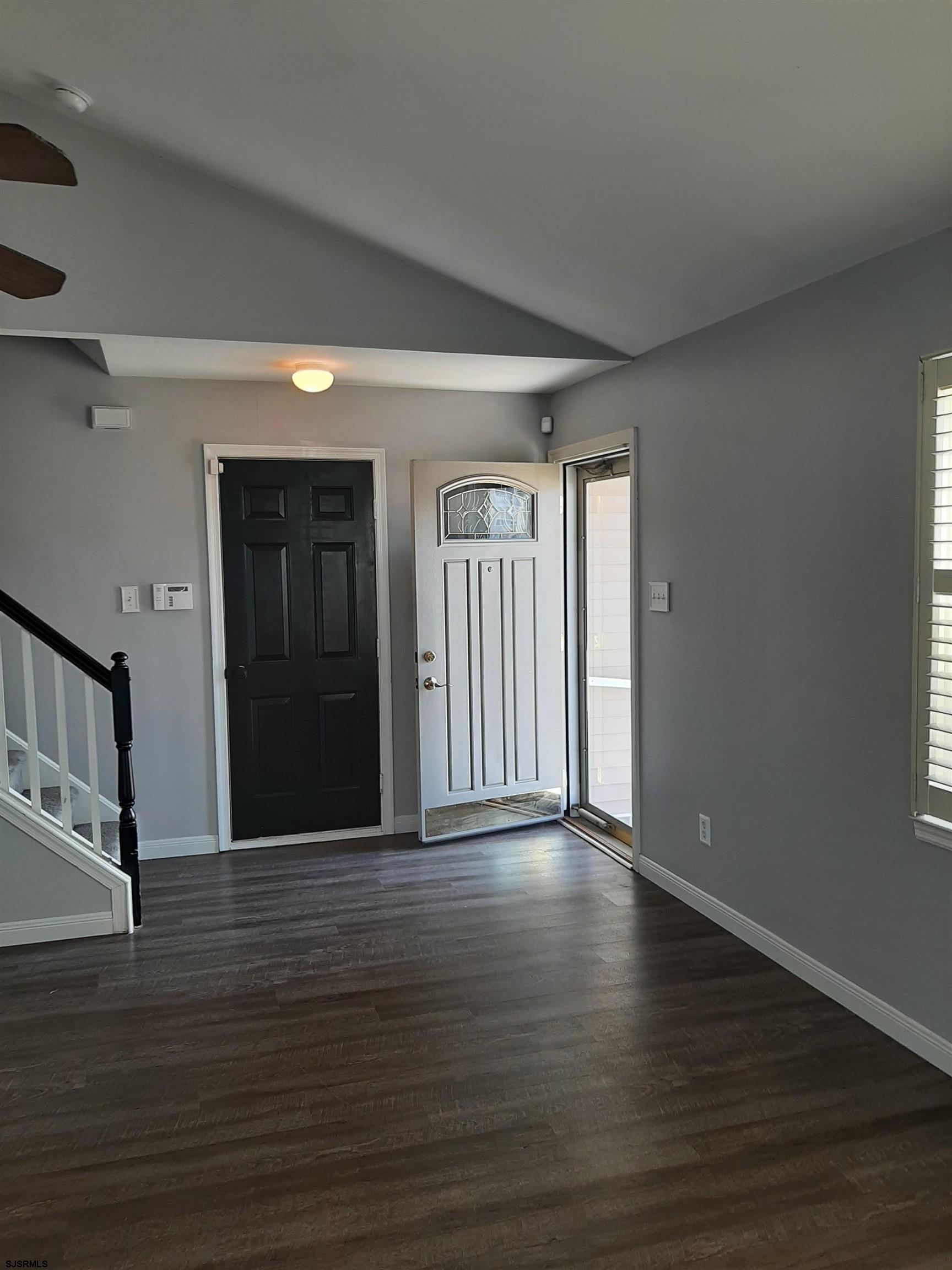 9 Pacific Avenue, Unit 9 Somers Point, NJ 08244 - Photo 3 of 19 a view of an empty room with wooden floor and a window