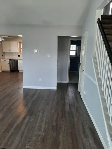 a view of entryway with wooden floor and stairs