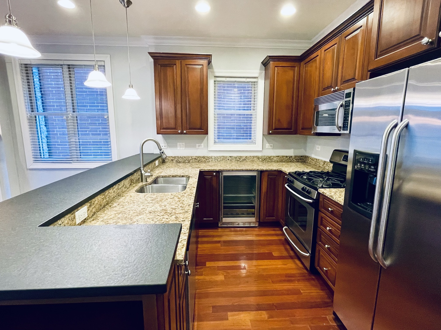 1053 West Cornelia Avenue, Unit 2 Chicago, IL 60657 - Photo 3 of 14 a kitchen with stainless steel appliances granite countertop a sink stove and refrigerator