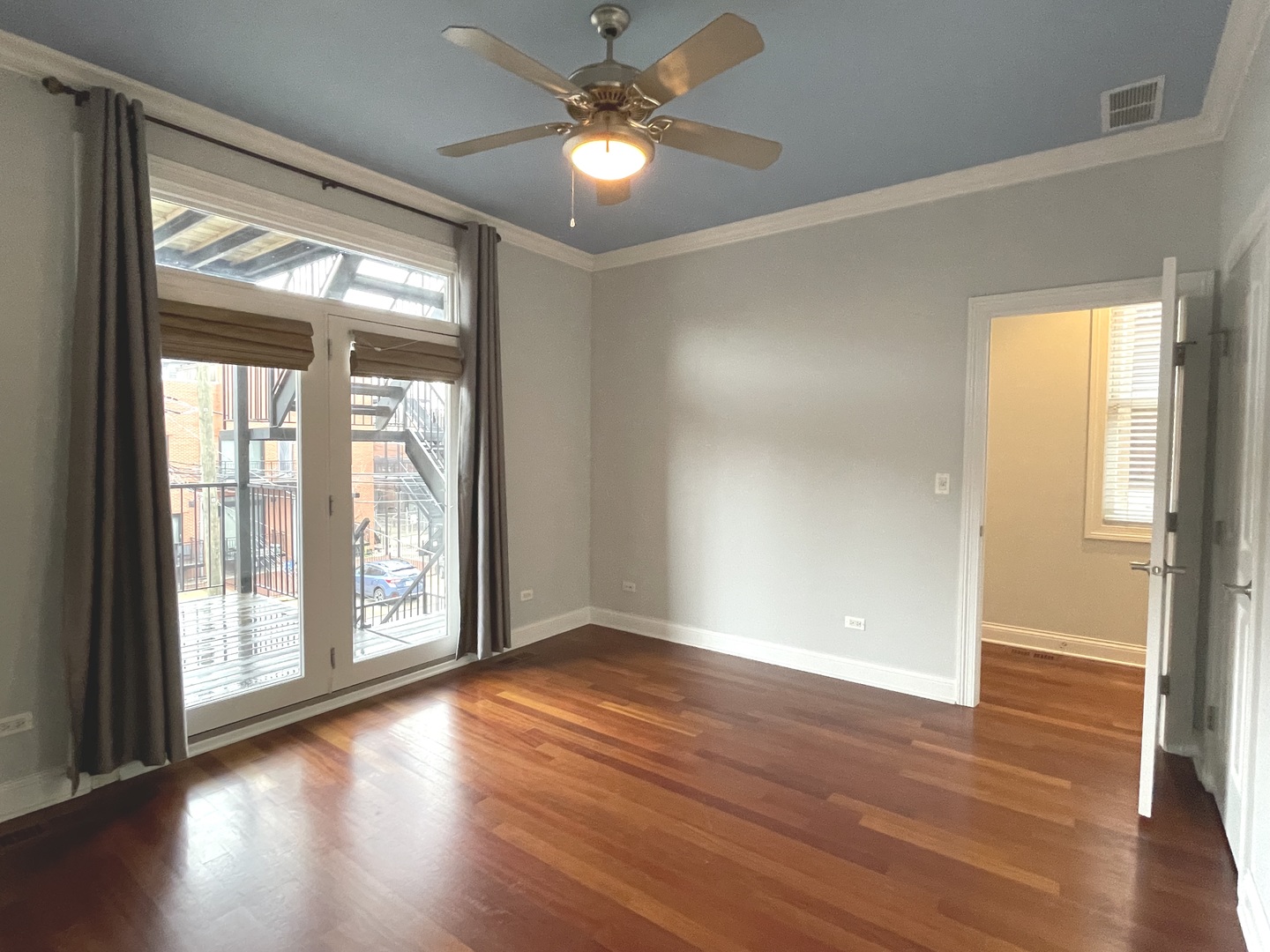 1053 West Cornelia Avenue, Unit 2 Chicago, IL 60657 - Photo 8 of 14 wooden floor in an empty room with a window