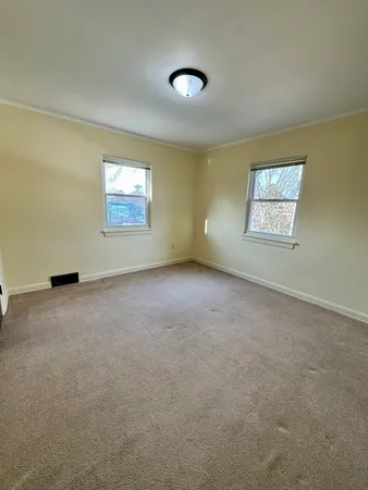 a view of an empty room with a lamp