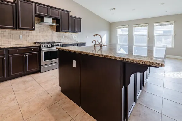 a kitchen with stainless steel appliances granite countertop a sink and stove