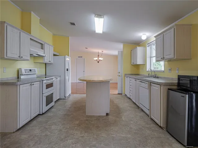 a kitchen with a sink stove and cabinets
