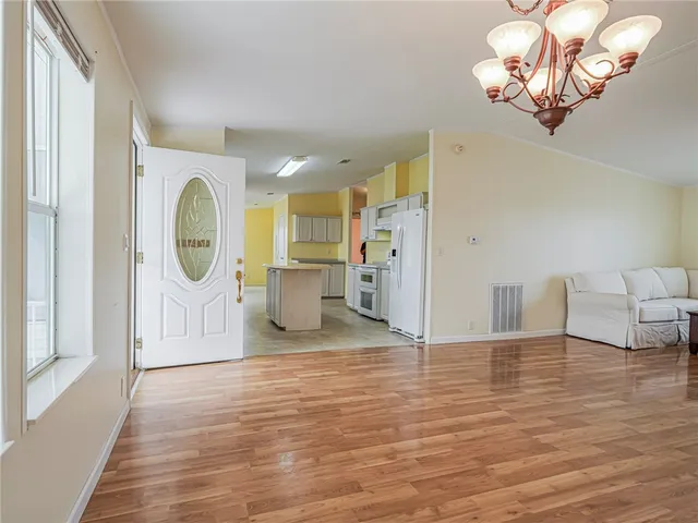 a view of a livingroom with a furniture wooden floor and a window