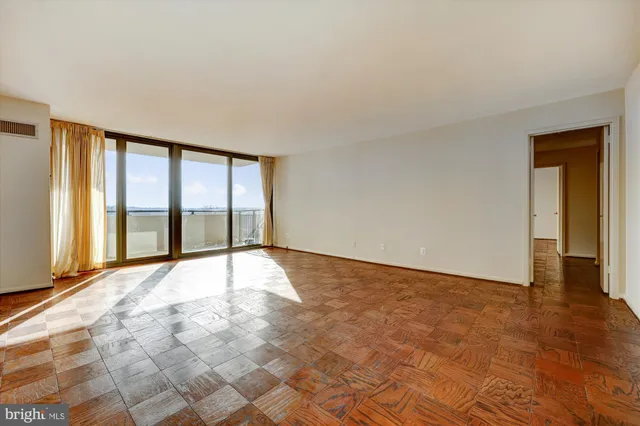 a view of an empty room and wooden floor