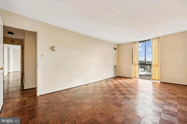 a living room with furniture a rug and a large window
