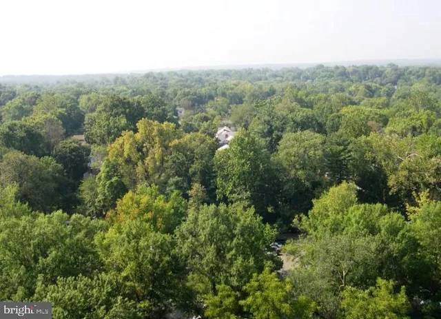 a view of a patio with table and chairs under an umbrella