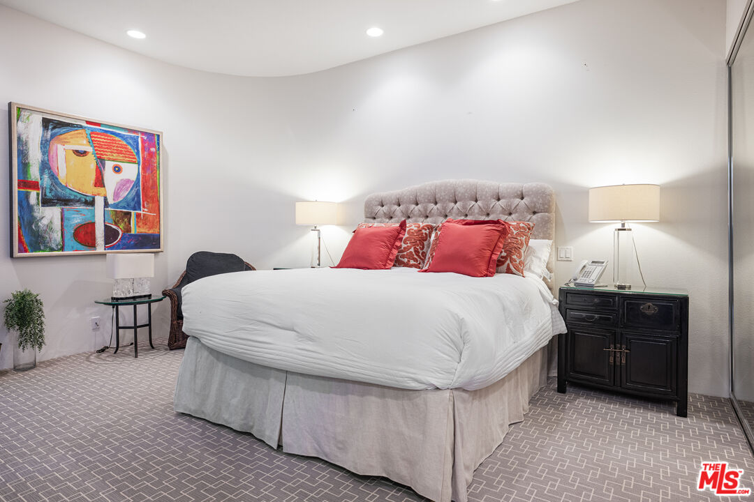 6 Rocky Lane Rancho Mirage, CA 92270 - Photo 47 of 57 a bedroom with bed and paintings on dresser