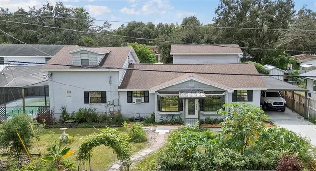 a aerial view of a house next to a yard