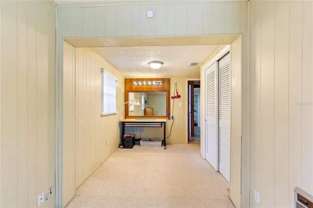 a view of a hallway with entryway door