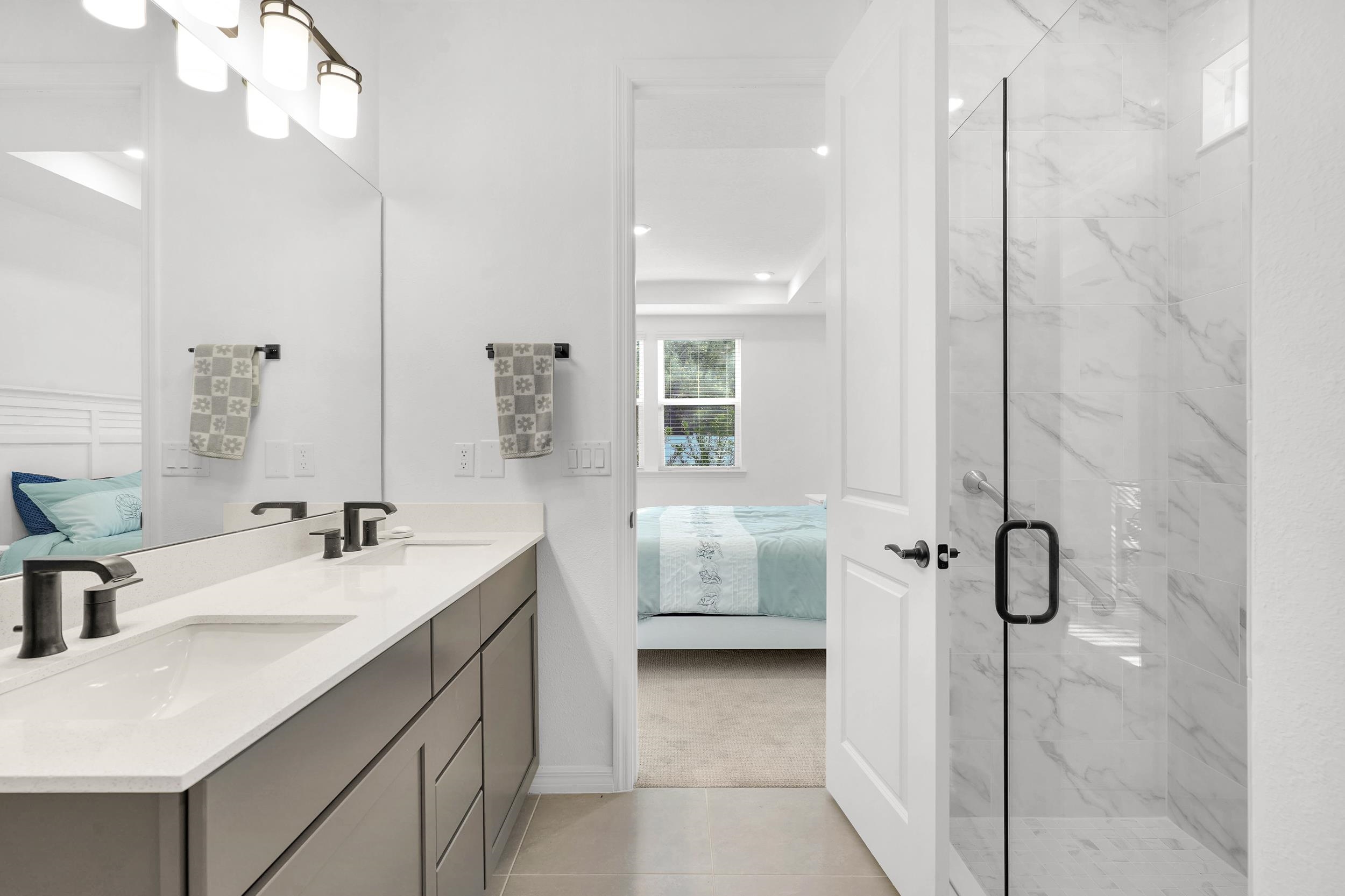 127 Shell Crk Court St. Augustine, FL 32086 - Photo 20 of 37 a bathroom with a double vanity sink a mirror and shower