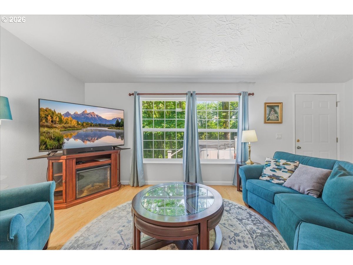 475 East 9th Street Rainier, OR 97048 - Photo 4 of 43 a living room with furniture a window and a flat screen tv