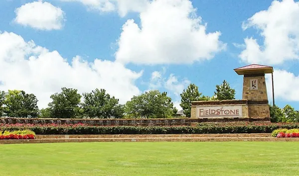 a view of a house with a big yard and potted plants