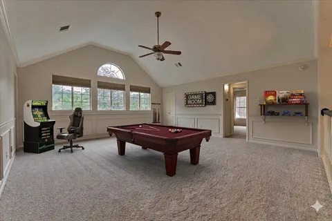 a living room with furniture a chandelier and a large window