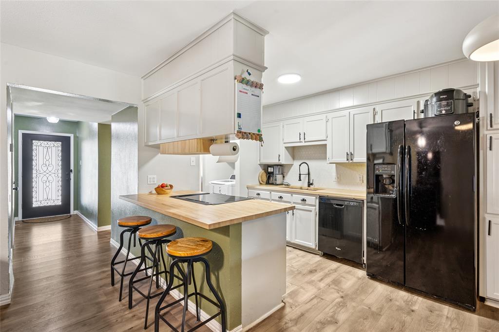 248 Mountain View Drive Azle, TX 76020 - Photo 4 of 26 a kitchen with a table chairs refrigerator and microwave