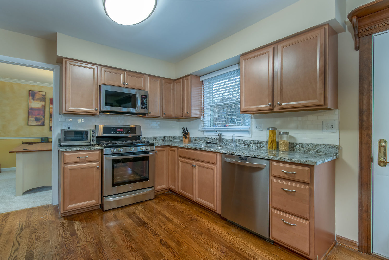 2105 Countryside Circle Naperville, IL 60565 - Photo 9 of 26 a kitchen with stainless steel appliances granite countertop a stove top oven a sink a microwave and cabinets