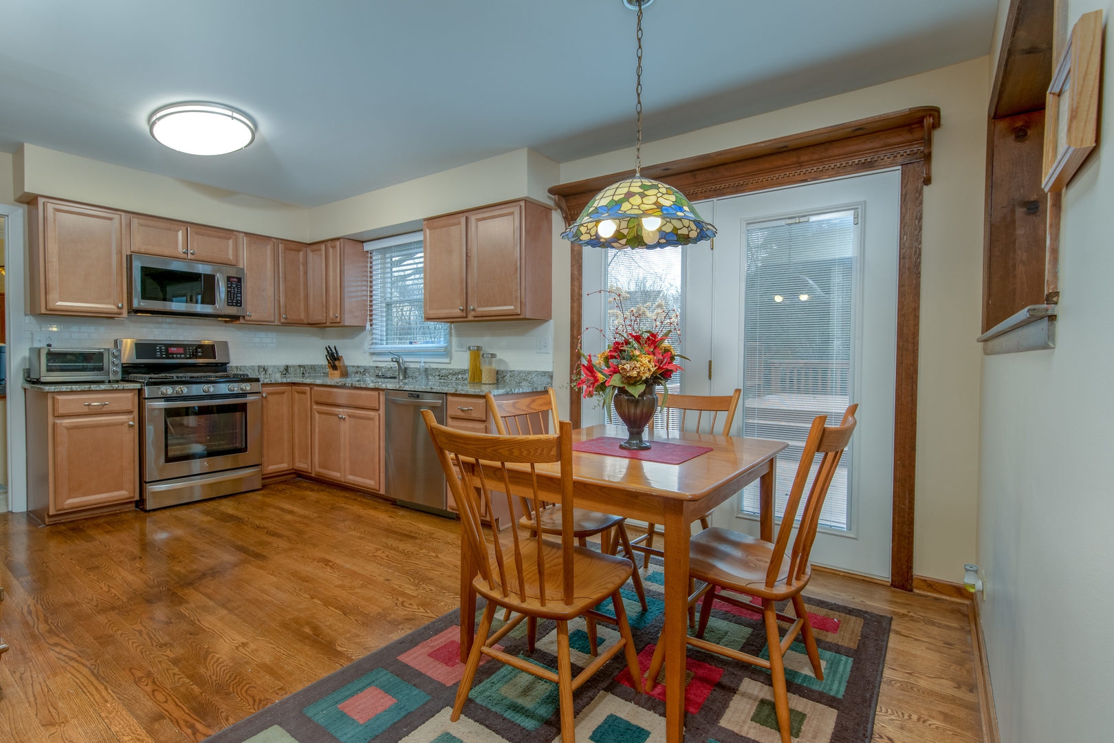 2105 Countryside Circle Naperville, IL 60565 - Photo 10 of 26 a kitchen with a table and chairs in it