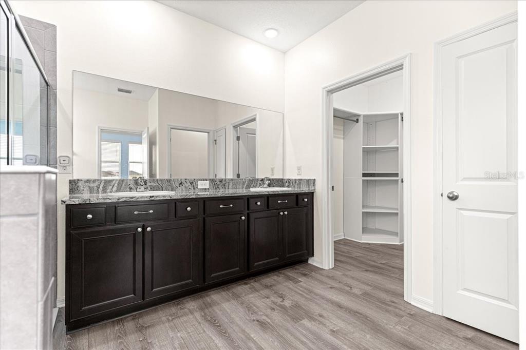 5851 Southwest 85th Place Ocala, FL 34476 - Photo 21 of 57 a spacious bathroom with a double vanity sink and a mirror