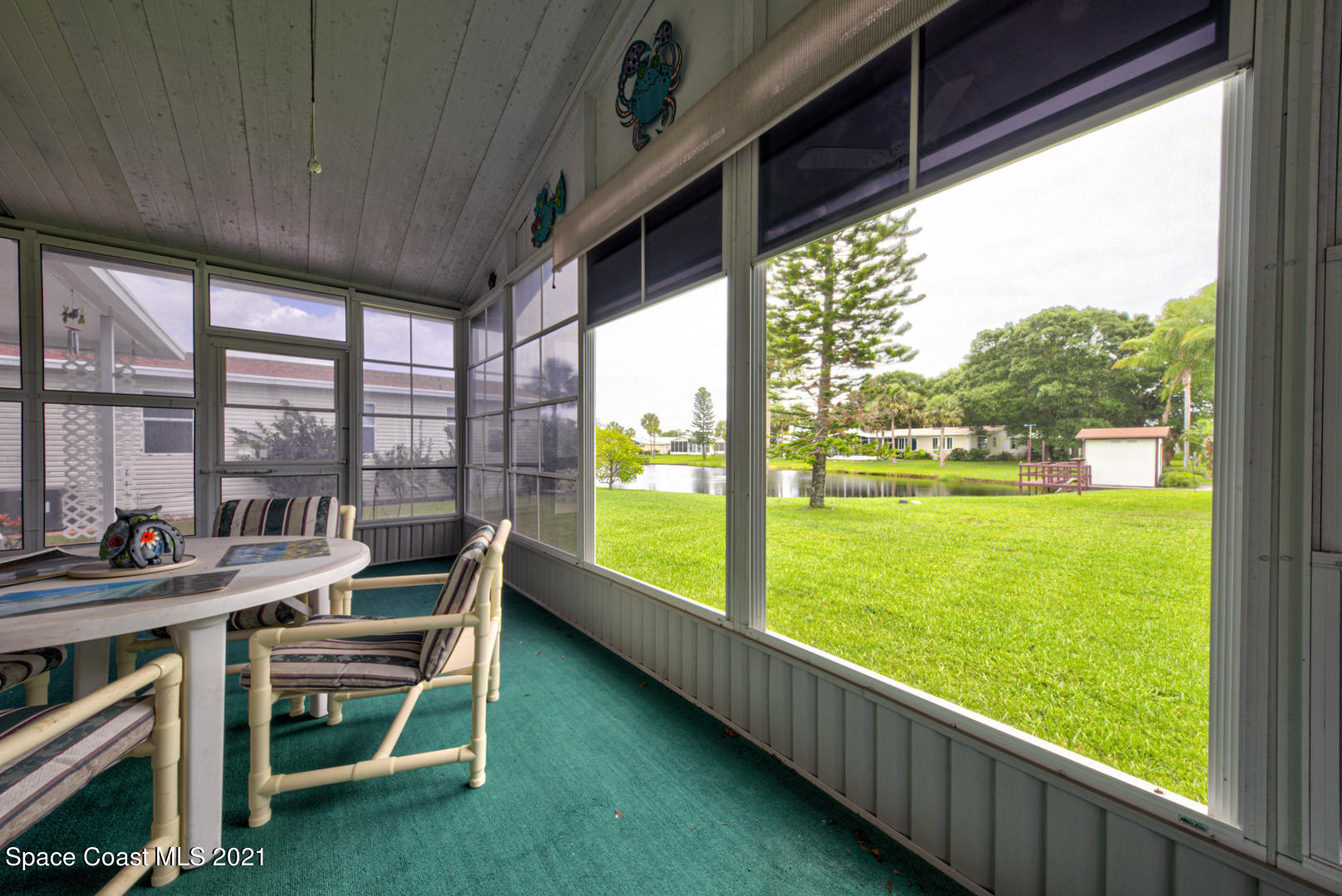 253 Timber Run Way, Unit 309 Cocoa, FL 32926 - Photo 34 of 38 screened-in porch with lake view
