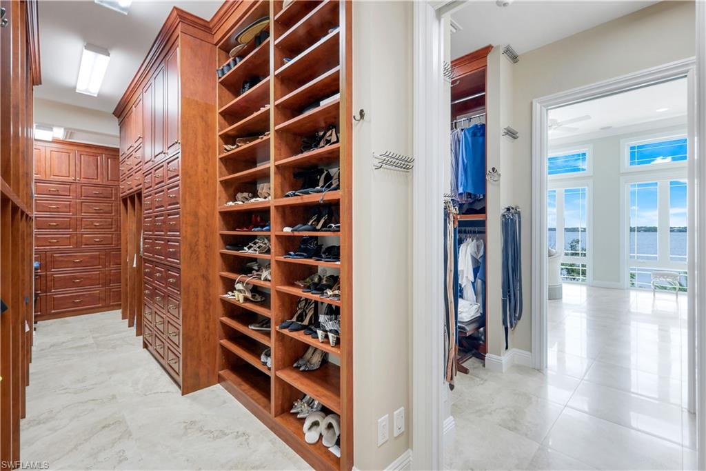 7159 Manasota Key Road Englewood, FL 34223 - Photo 25 of 50 a view of walk in closet with clothes and shoes