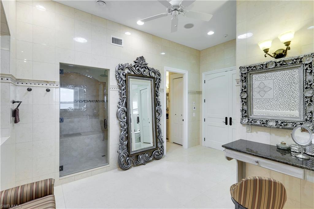 7159 Manasota Key Road Englewood, FL 34223 - Photo 28 of 50 a bathroom with a sink a light fixture and a mirror