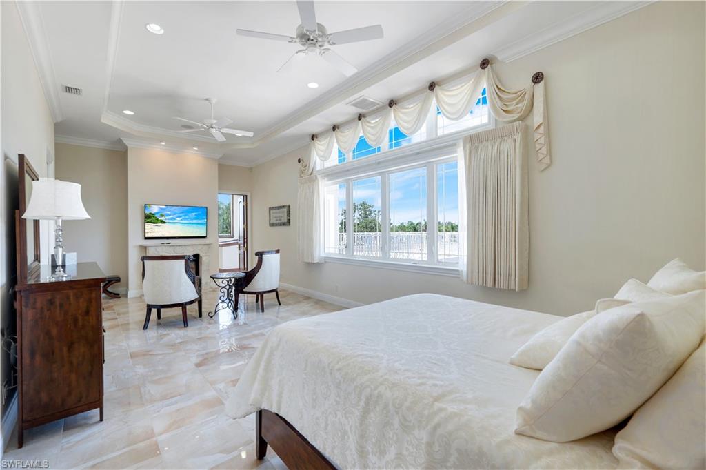 7159 Manasota Key Road Englewood, FL 34223 - Photo 32 of 50 Bedroom featuring crown molding, a raised ceiling, recessed lighting, and ceiling fan