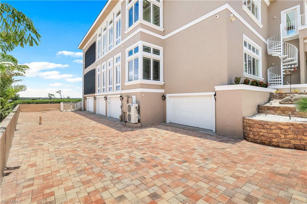 7159 Manasota Key Road Englewood, FL 34223 - Photo 36 of 50 View of garage entry on the left side of the house. Garage doors are also on the right side of the house