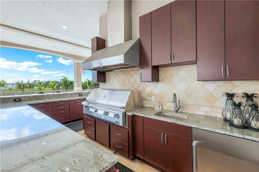 7159 Manasota Key Road Englewood, FL 34223 - Photo 36 of 50 a kitchen with stainless steel appliances granite countertop a sink and a stove